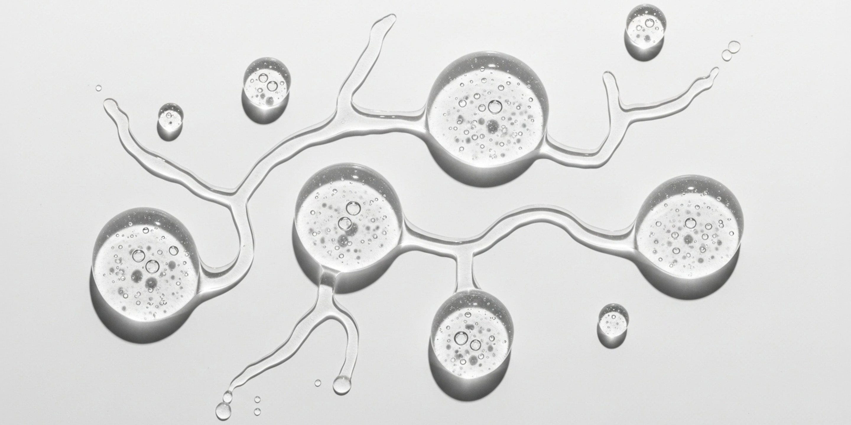 Close-up of water droplets on a surface with intricate patterns.